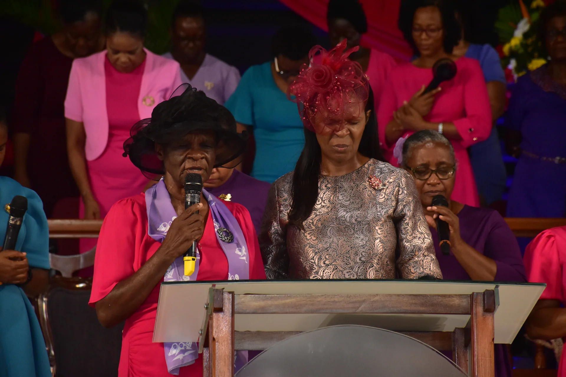 Women's Ministries leaders leading the congregation in prayer at Portmore Seventh-day Adventist Church